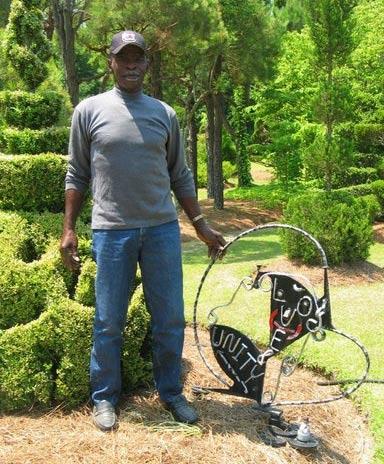 Fryar Stands Beside His Love & Unity Sculpture