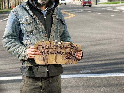 Homeless man holding sign